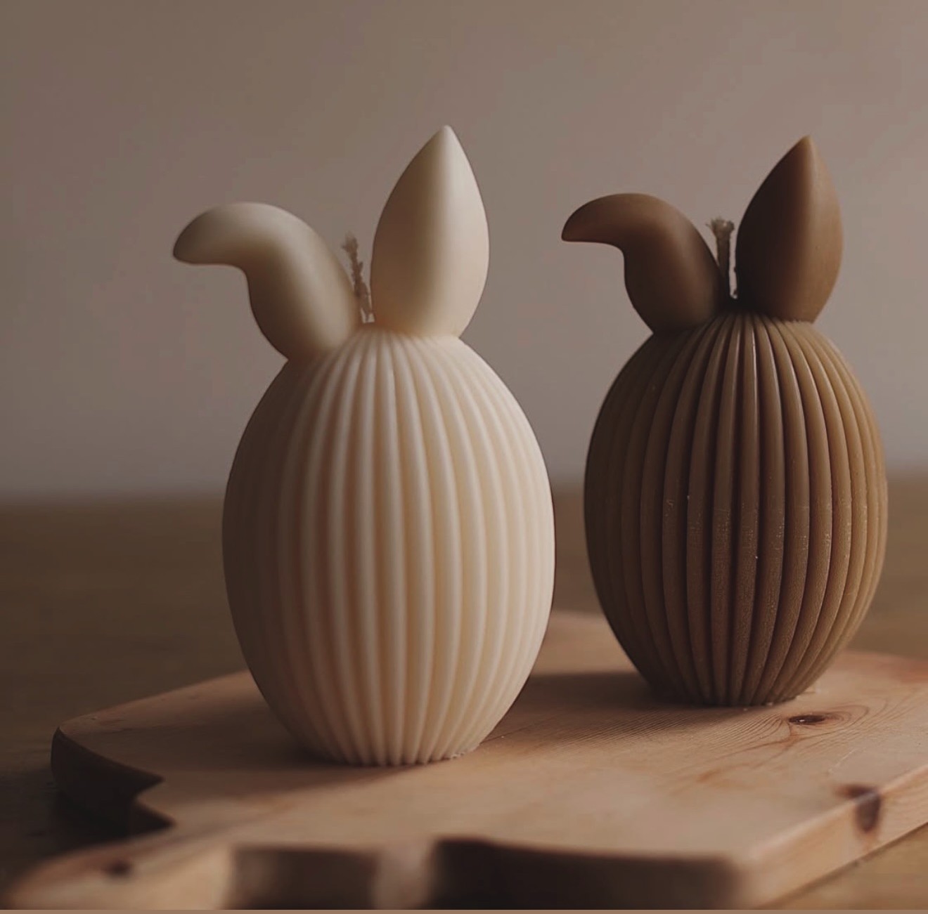 Bunny-ear ribbed candle duo on a wooden board